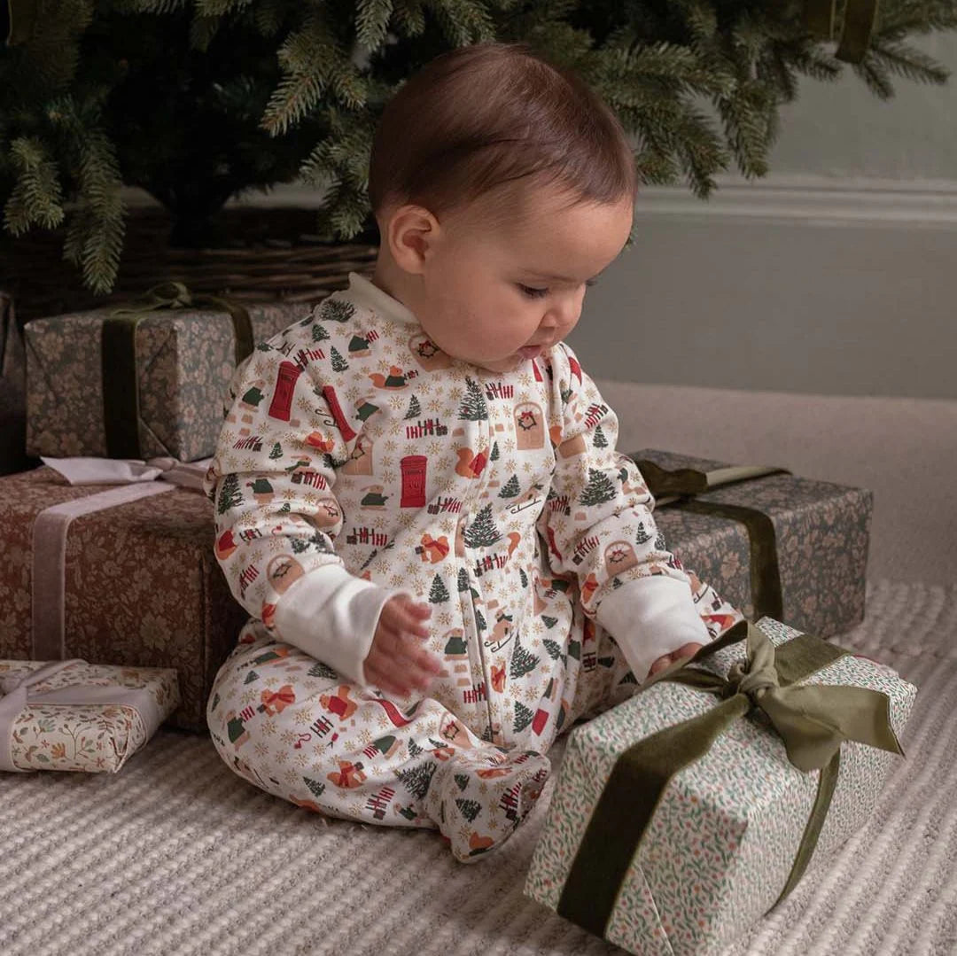 Avery Row Christmas sleepsuit sold by Mabel & Fox. 